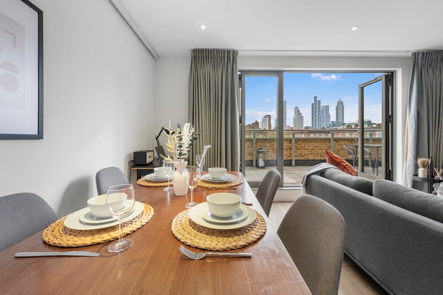 Dining table for four with the London skyline through the bifold terrace doors